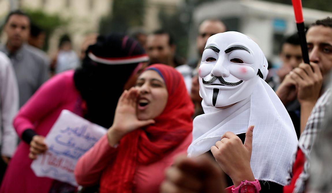 Egyptian protesters chant anti Muslim Brotherhood slogans during a demonstration outside the presidential palace, in Cairo, Egypt, Wednesday, Dec. 5, 2012. Egyptian  (AP Photo/Hassan Ammar)