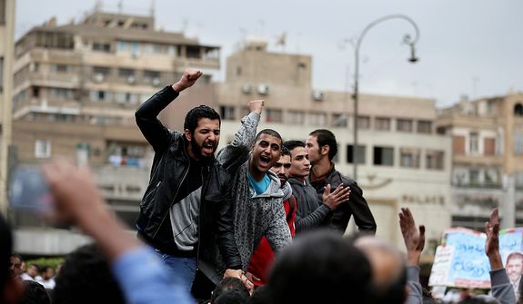 Egyptian protesters chant anti Muslim Brotherhood slogans outside the presidential palace, in Cairo, Egypt, Wednesday, Dec. 5, 2012. Supporters of President Mohammed Morsi and opponents clashed outside the presidential palace.  (AP Photo/Hassan Ammar)