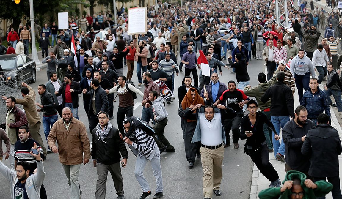 Egyptian President Mohammed Morsi&#x27;s supporters clash with opponents, not pictured, outside the presidential palace, in Cairo, Egypt, Wednesday, Dec. 5, 2012.  (AP Photo/Hassan Ammar)