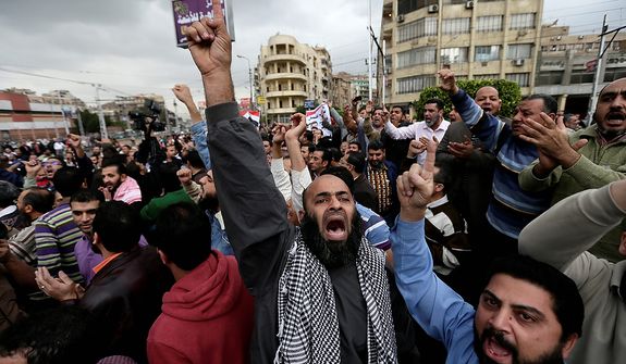 A supporter of Egyptian President Mohammed Morsi chants slogans during clashes with opponents, not pictured, outside the presidential palace, in Cairo, Egypt, Wednesday, Dec. 5, 2012.  (AP Photo/Hassan Ammar)
