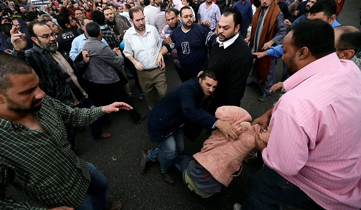 Egyptian President Mohammed Morsi&#x27;s supporters try to detain an opposition protester during clashes outside the presidential palace, in Cairo, Egypt, Wednesday, Dec. 5, 2012. Wednesday&#x27;s clashes began when thousands of Islamist supporters of Morsi descended on the area around the palace where some 300 of his opponents were staging a sit-in. (AP Photo/Hassan Ammar)