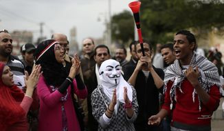 Egyptian protesters chant anti-Muslim Brotherhood slogans outside the presidential palace in Cairo on Wednesday, Dec. 5, 2012. (AP Photo/Hassan Ammar)
