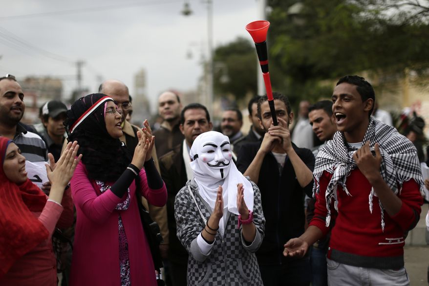 Egyptian protesters chant anti-Muslim Brotherhood slogans outside the presidential palace in Cairo on Wednesday, Dec. 5, 2012. (AP Photo/Hassan Ammar)