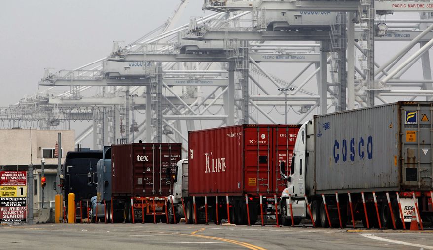 Trucks wait in long lines to load at the Port of Long Beach, Calif., on Tuesday, Dec. 4, 2012. (AP Photo/Nick Ut)