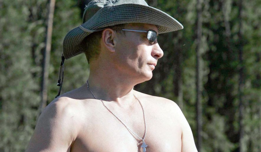 ** FILE ** Russian President Vladimir Putin strips off his shirt while fishing in the Siberian mountains in 2007. (Associated Press)