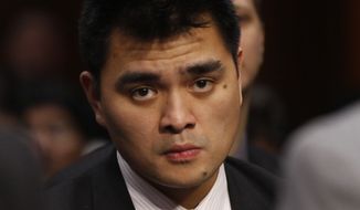 **FILE** Jose Antonio Vargas, Pulitzer Prize winning journalist and immigration reform activist, listens June 28, 2011, as Homeland Security Secretary Janet Napolitano and Education Secretary Arne Duncan testify at a hearing regarding immigration reform and the DREAM Act on Capitol Hill in Washington. (Associated Press)