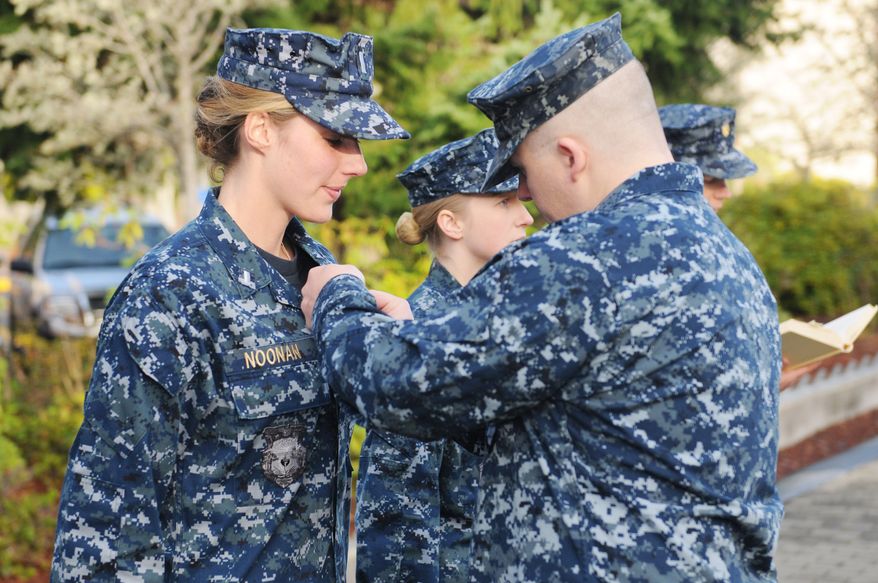Lt. j.g. Jennifer Noonan, assigned to the Blue crew of the ballistic missile submarine USS Maine (SSBN 741), receives her submarine warfare officer device from former shipmate Lt. Jason Brethauer during a Dec. 5, 2012, ceremony at Naval Base Kitsap in Bangor, Wash. Noonan is one of three Sailors to become the first female unrestricted line officers to qualify in submarines. (Chief Mass Communication Specialist Ahron Arendes/U.S. Navy)