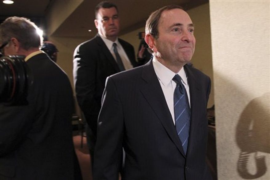 NHL commissioner Gary Bettman leaves the room after speaking to reporters after an NHL Board of Governors meeting, Wednesday, Dec. 5, 2012 in New York. The league and the NHL Players' Association have cleared their schedules with progress being made in collective bargaining talks. (AP Photo/Mary Altaffer)