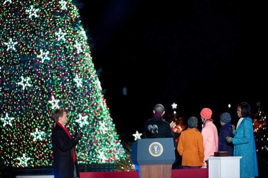President Obama and the first family admire the National Christmas Tree after it was lit. Neil Patrick Harris claps at left. (Andrew Harnik/The Washington Times)