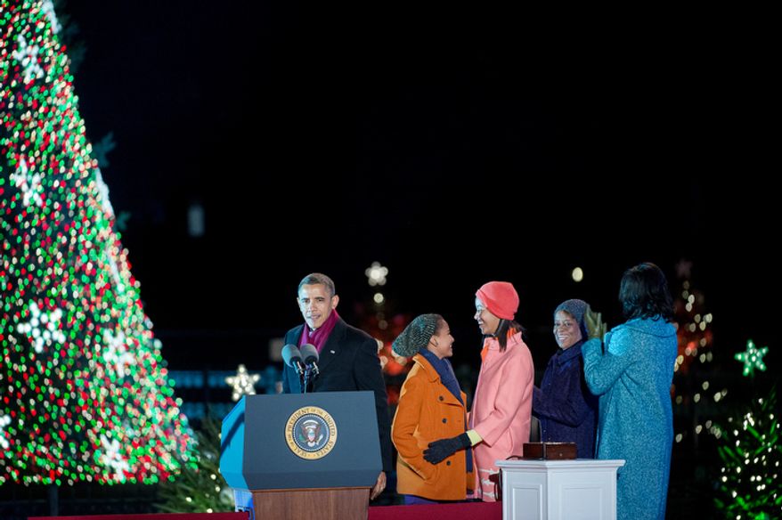 President Obama and the first family cheer after lighting the National Christmas Tree. (Andrew Harnik/The Washington Times)