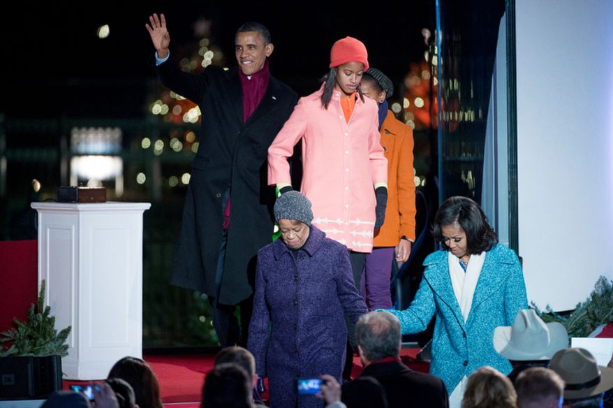 President Obama and the first family take their seats after lighting the National Christmas Tree on the Ellipse. (Andrew Harnik/The Washington Times)
