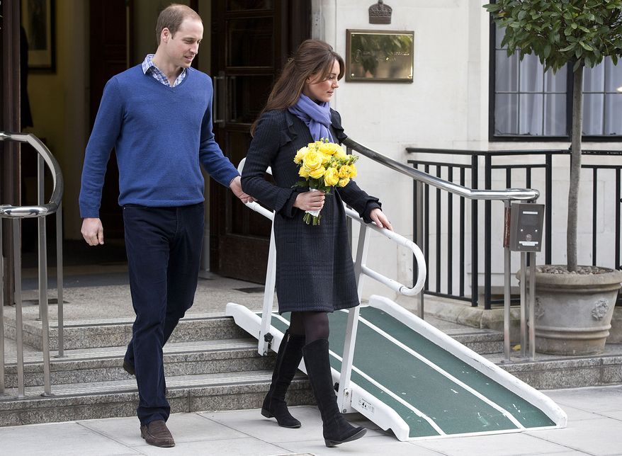 **FILE** Britain's Prince William stand next to his wife Kate, Duchess of Cambridge, as she leaves the King Edward VII hospital in central London on Dec. 6, 2012. They are expecting their first child, and the Duchess was admitted to hospital suffering from a severe form of morning sickness in the early stages of her pregnancy. (Associated Press)