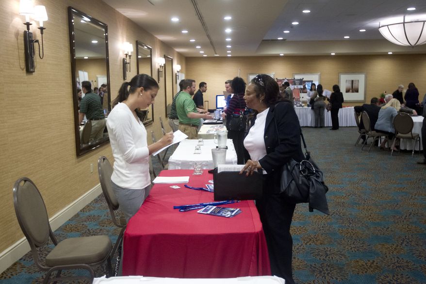 A person fills out an application at the Fort Lauderdale Career Fair in Dania Beach, Fla., on Nov. 30, 2012. (Associated Press)