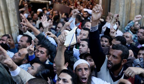 Muslim Brotherhood and Egyptian President Morsi supporters chant slogans during a funeral of three victims who were killed during Wednesday&#39;s clashes outside Al Azhar mosque, the highest Islamic Sunni institution, Friday, Dec. 7, 2012. During the funeral, thousands Islamist mourners chanted, &quot;with blood and soul, we redeem Islam,&quot; pumping their fists in the air. &quot;Egypt is Islamic, it will not be secular, it will not be liberal,&quot; they chanted as they walked in a funeral procession that filled streets around Al-Azhar mosque. Thousands of Egyptians took to the streets after Friday midday prayers in rival rallies and marches across Cairo, as the standoff deepened over what opponents call the Islamist president&#39;s power grab, raising the specter of more violence. (AP Photo/Hassan Ammar)