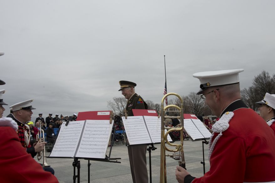 A veteran comes up to chat with the Marine Band brass quintet before the National Pearl Harbor Remembrance Day ceremony at the National World War II Memorial on Friday, Dec. 7, 2012. (Barbara L. Salisbury/The Washington Times)