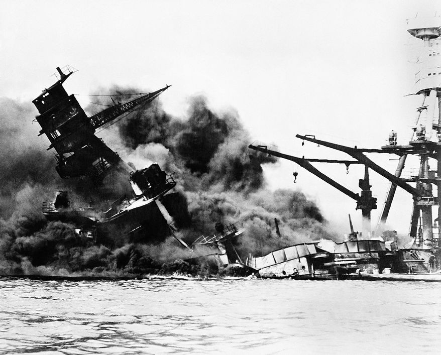 The battleship USS Arizona belches smoke as it topples over into the sea during Japanese surprise attack on Pearl Harbor, Hawaii, December 7, 1941. The ship sank with more than 80 percent of its 1,500-man crew, including Rear Admiral Issac C. Kidd. The attack, which left 2,343 Americans dead and 916 missing, broke the backbone of the U.S. Pacific Fleet and forced America out of a policy of isolationism. President Franklin D. Roosvelt announced that it was "a date which will live in infamy" and Congress declared war on Japan the morning after. This was the first attack on American territory since 1812. (AP Photo)