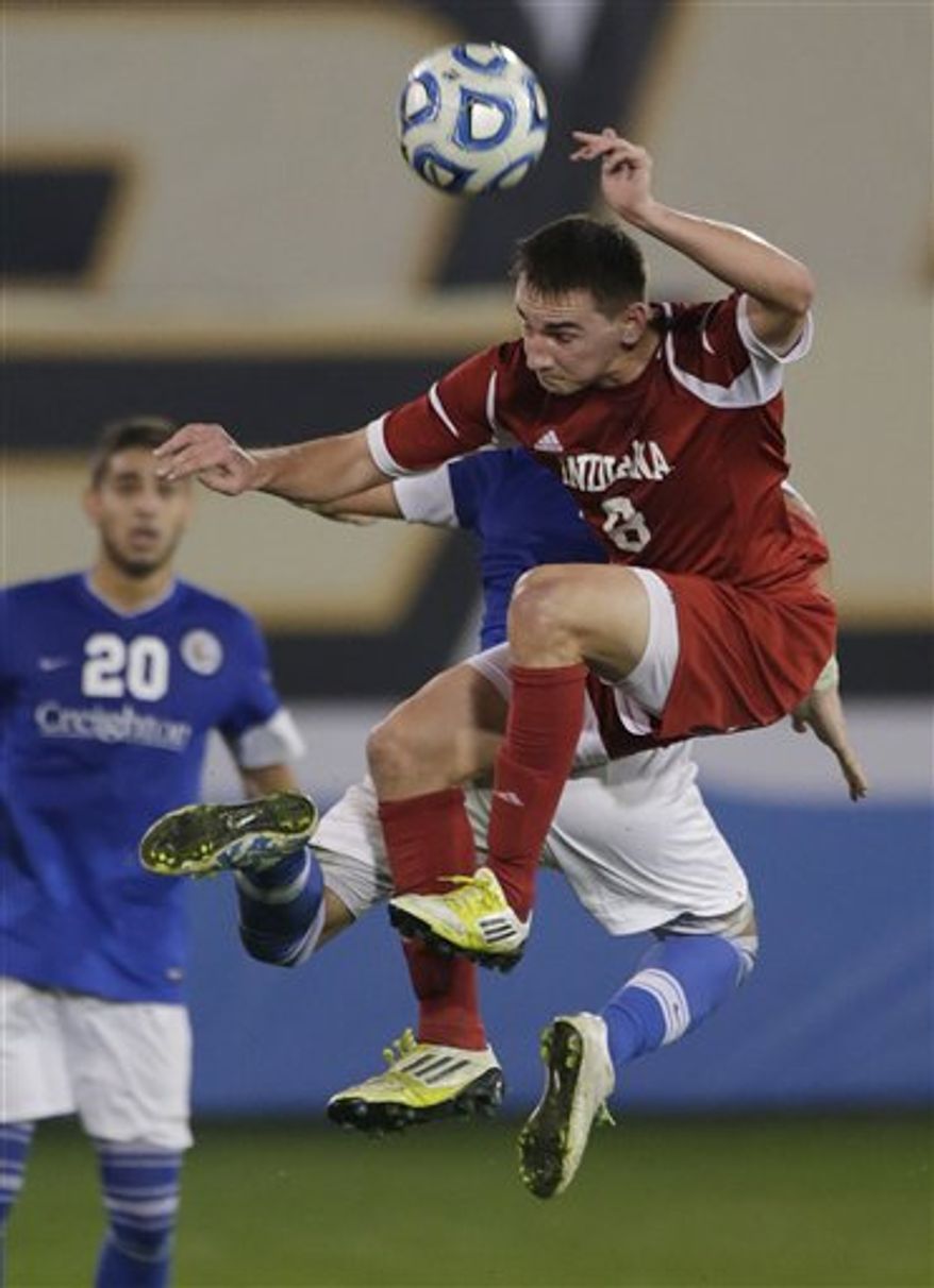 Indiana's Nikita Kotlov (8) battles for the ball with Creighton's Bruno Castro, rear, as Christian Blandon (20) watches in the second half of a NCAA College Cup men's championship semifinal soccer match at Regions Park, Friday, Dec. 7, 2012, in Hoover, Ala. Indiana won 1-0. (AP Photo/Dave Martin)