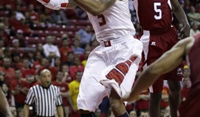Maryland guard Nick Faust shoots past South Carolina State guard Adama Adams, of Senegal, in the second half of an NCAA college basketball game in College Park, Md., Saturday, Dec. 8, 2012. Maryland won 61-46. (AP Photo/Patrick Semansky)