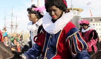 People dressed as Zwarte Piet or Black Pete ride in a parade after St. Nicholas arrives by boat in Amsterdam. Foreigners visiting the Netherlands in winter are often surprised to see that the Dutch version of St. Nicholas’ helpers resemble a racist caricature of a black man. The Dutch, known for tolerance, are also starting to question the tradition. (Associated Press)