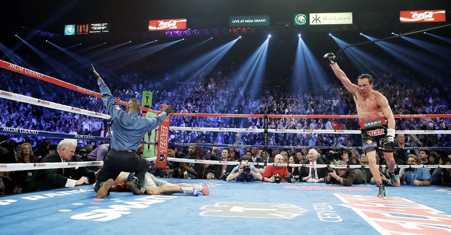 associated press
Referee Kenny Bayless calls the fight Saturday as Juan Manuel Marquez celebrates after knocking out Manny Pacquiao at the MGM Grand Garden Arena in Las Vegas.