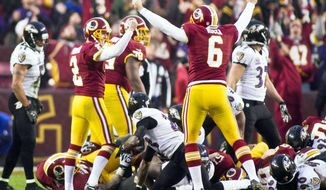 Redskins kicker Kai Forbath (2) celebrates with holder Sav Rocca after converting the winning 34-yard field goal in overtime against the Ravens on Sunday. (Craig Bisacre/The Washington Times)