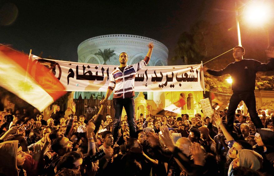 Hostility: Opposition activists rally Sunday in front of the presidential palace in Cairo and intend to keep up the momentum of its street campaign. Supporters of President Mohammed Morsi plan demonstrations at the same time. (Associated Press)
