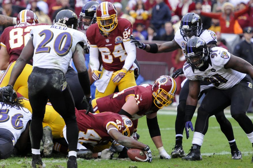 Washington Redskins running back Alfred Morris (46) reaches the ball across the goal line for a first-quarter touchdown against the Raven's at FedEx Field, Landover, Md., Dec. 9, 2012. (Preston Keres/Special to The Washington Times)