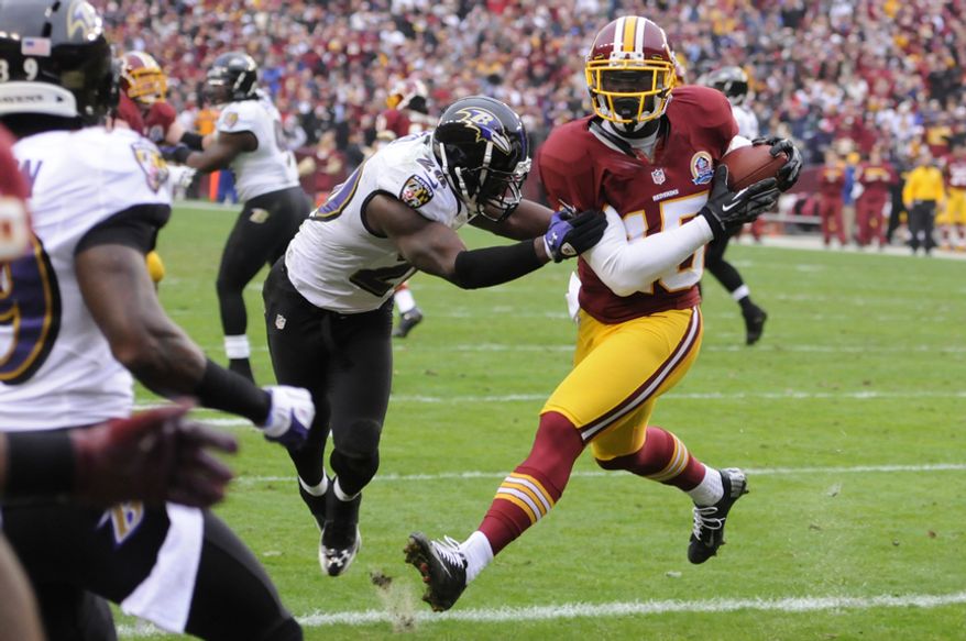 Washington Redskins wide receiver Josh Morgan (15) hauls in a 4-yard touchdown pass in front of Baltimore Ravens free safety Ed Reed (20) for the first score of the gam at FedEx Field, Landover, Md., Dec. 9, 2012. (Preston Keres/Special to The Washington Times)
