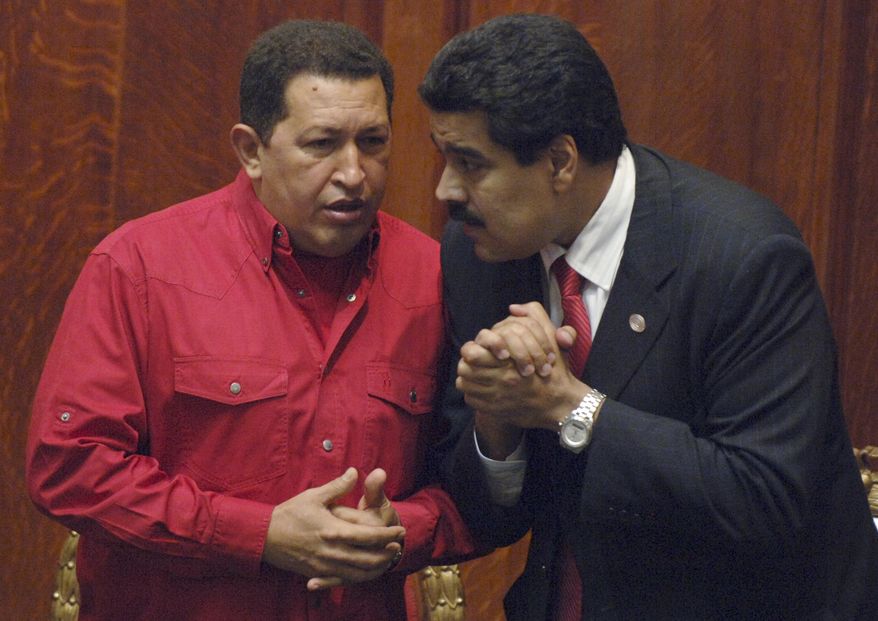 ** FILE ** Venezuelan President Hugo Chavez (left) talks with then-Foreign Minister Nicolas Maduro at the University of Uruguay in Montevideo, Uruguay, in December 2007. (AP Photo/Matilde Campodonico)