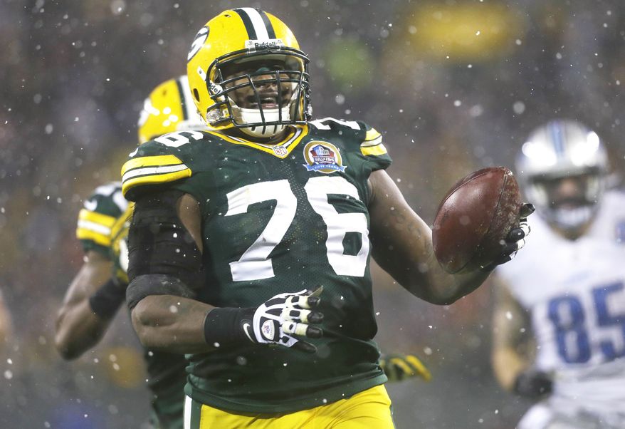 Green Bay Packers defensive end Mike Daniels (76) picks up a fumble by Detroit Lions quarterback Matthew Stafford and runs it back 43-yards for a touchdown during the first half of an NFL football game Sunday, Dec. 9, 2012, in Green Bay, Wis. (AP Photo/Jeffrey Phelps)