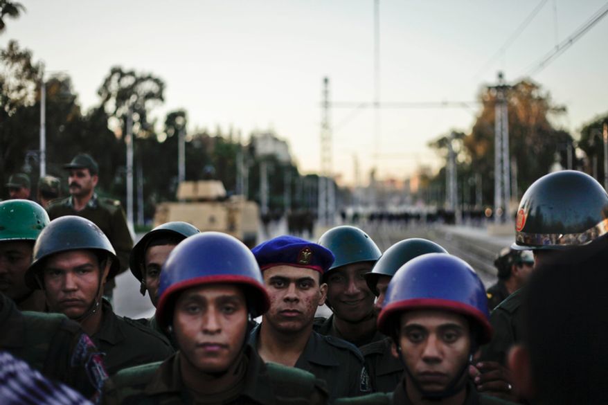 Egyptian army soldiers stand guard during a demonstration in front of the presidential palace in Cairo on Dec. 7, 2012. (Associated Press)