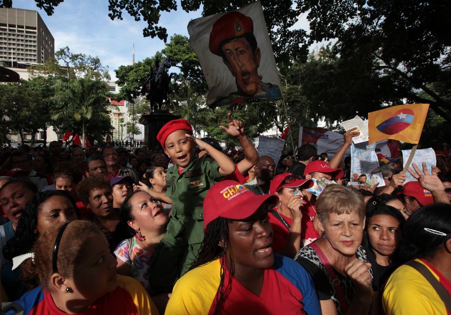 People attend a demonstration in support of Venezuela's President Hugo Chavez at the Simon Bolivar square in Caracas, Venezuela, on Dec. 9, 2012. (Associated Press)