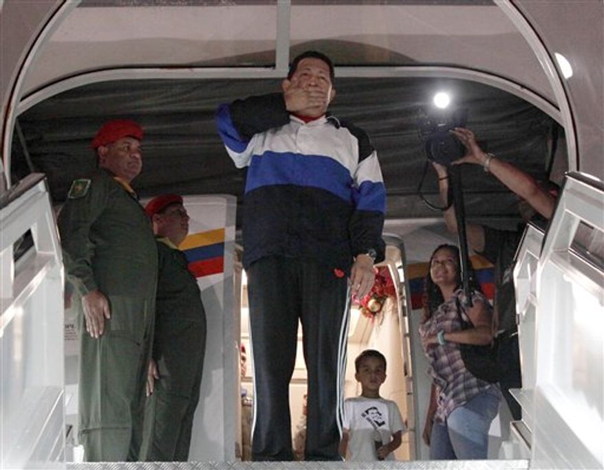 Venezuelan President Hugo Chavez (center) blows a goodbye kiss prior to boarding his plane at the Simon Bolivar International airport in Maiquetia near Caracas, Venezuela, on Dec 10, 2012. (Associated Press/Miraflores Press Office)