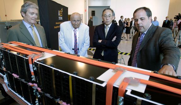 **FILE** U.S. Energy Secretary Steven Chu (second from right) listens as Jason Forcier (right), vice president and general manager of A123 Systems, shows off a battery at their plant in Romulus, Mich., on July 18, 2011. Standing at left is A123 President and CEO David Vieau and Rep. John Dingell, Michigan Democrat. (Associated Press)