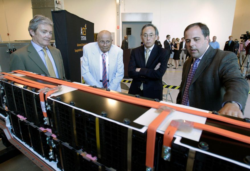 **FILE** U.S. Energy Secretary Steven Chu (second from right) listens as Jason Forcier (right), vice president and general manager of A123 Systems, shows off a battery at their plant in Romulus, Mich., on July 18, 2011. Standing at left is A123 President and CEO David Vieau and Rep. John Dingell, Michigan Democrat. (Associated Press)