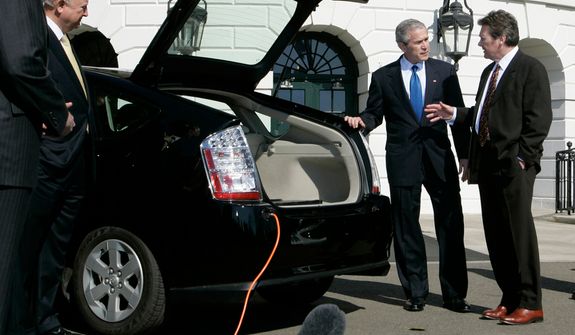 **FILE** President Bush (center) listens to Dave Vieau (right), president and CEO of A123 Systems, as he is shown a Toyota Prius plug-in hybrid car utilizing a lithium power battery during a demonstration of alternative fuel automobiles on the South Lawn of the White House in Washington on Feb. 23, 2007. At left is Energy Secretary Sam Bodman. (Associated Press)