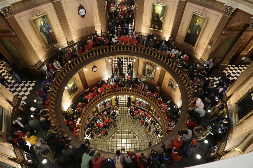 Protesters gather for a rally in the Capitol Rotunda in Lansing, Mich., on Tuesday, Dec. 11, 2012. The crowd is demonstrating against legislation that could make Michigan the 24th state with a right-to-work law. (AP Photo/Paul Sancya)