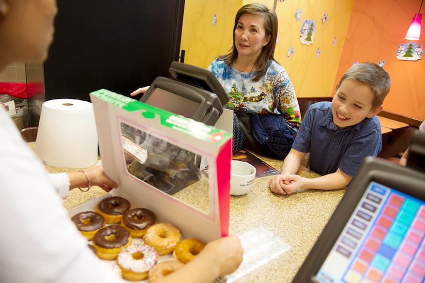 Vienna, Va. resident Wil Hiday gets donuts after school with his mom Kim on Tuesday, Dec. 11, 2012 at Dunkin' Donuts in Vienna. Wil is going to bring the donuts to school Wednesday, when he turns 12 years old on 12/12/12. Tonight the family is going to celebrate at IHOP at the stroke of midnight. (Barbara L. Salisbury/The Washington Times)