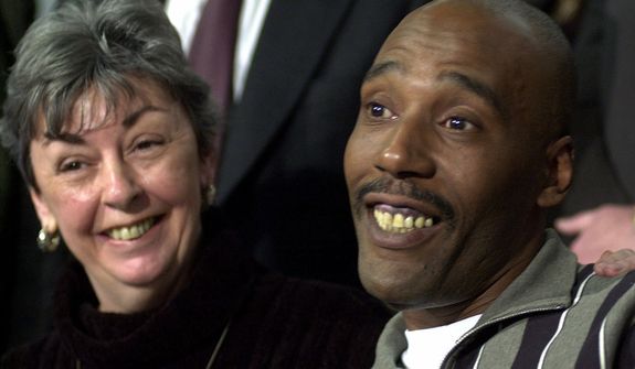 **FILE** Former death row inmate Earl Washington Jr. smiles during a Feb. 12, 2001, news conference in Virginia Beach, Va., as Marie Deans, a member of his legal team, listens. Washington was released from prison thanks to DNA tests showing he was wrongly convicted in the 1982 rape and slaying of Rebecca Lynn Williams. (Associated Press)