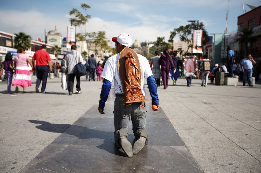 A pilgrim walks on his knees carrying an image of the Virgin of Guadalupe on his back as he makes his way to the Basilica of Guadalupe in Mexico City, Tuesday Dec. 11, 2012. Nationwide, devotees of the Virgin of Guadalupe make a pilgrimage to the basilica in honor of her Dec. 12 feast day. (AP Photo/Denisse Pohls)