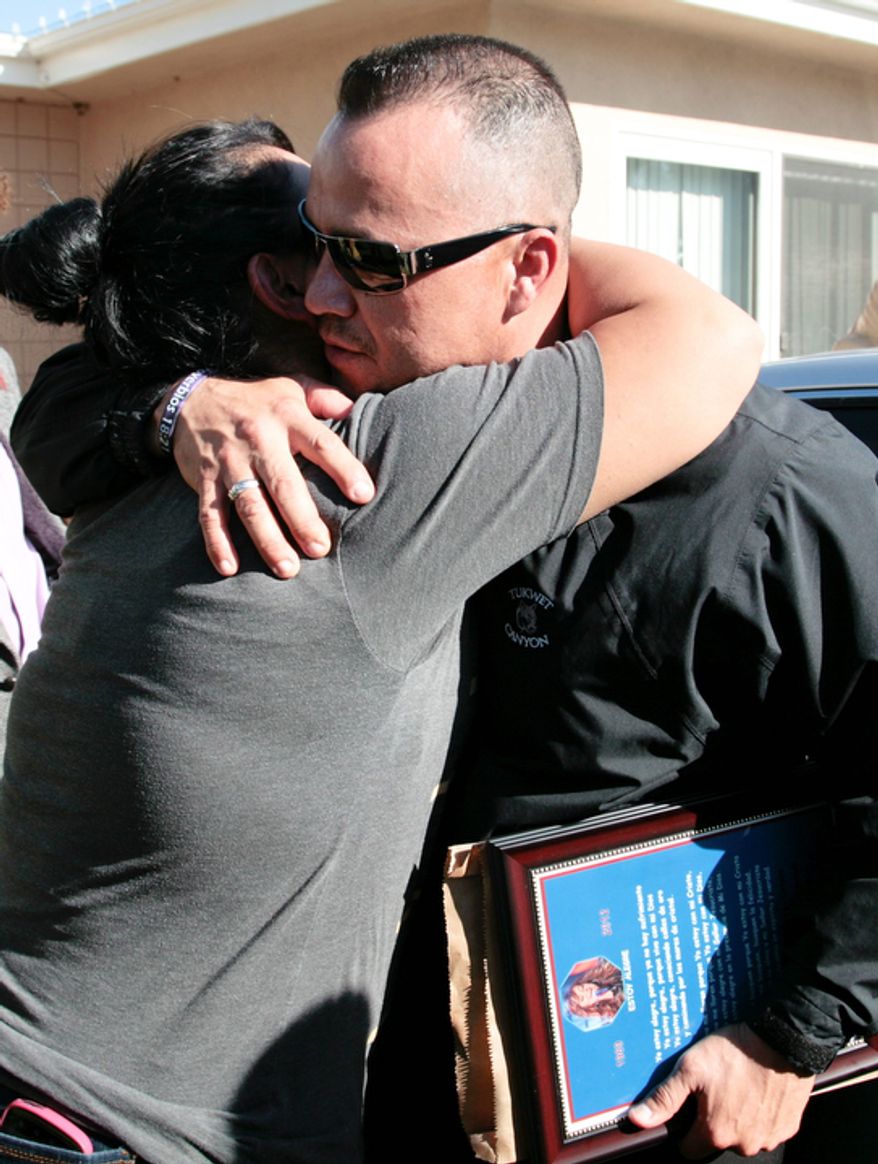 Pedro Rivera Jr. (right), brother of singer Jenni Rivera, is greeted by a well-wisher as he arrives at his mother's home in Lakewood, Calif., on Dec. 10, 2012. Jenni Rivera died Dec. 9 in a plane crash in Mexico. (Associated Press)