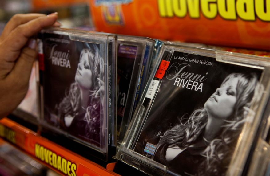 A person takes a CD of singer Jenni Rivera displayed for sale at a music store in Mexico City on Dec. 10, 2012. U.S. authorities confirmed that Rivera, a U.S.-born singer whose soulful voice and openness about her personal troubles made her a Mexican-American superstar, was killed in a Dec. 9 plane crash in northern Mexico. (Associated Press)