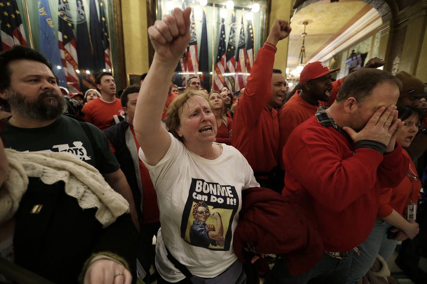Demonstrators gather for a rally in the rotunda at the State Capitol in Lansing, Mich., on Dec. 11, 2012, to protest right-to-work legislation passed the previous week. (Associated Press)