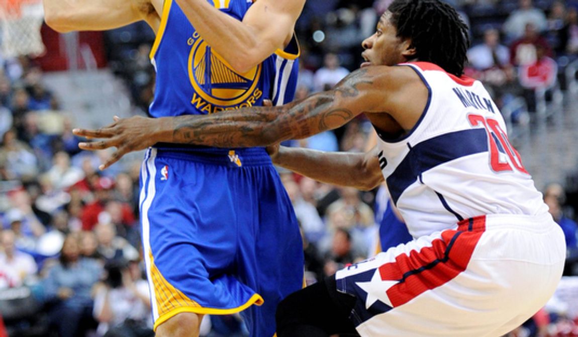 Golden State Warriors guard Stephen Curry (left) tries to get around Washington Wizards forward Cartier Martin during the first half of the Warriors&#x27; 101-97 win on Dec. 8, 2012, in Washington. (Associated Press)