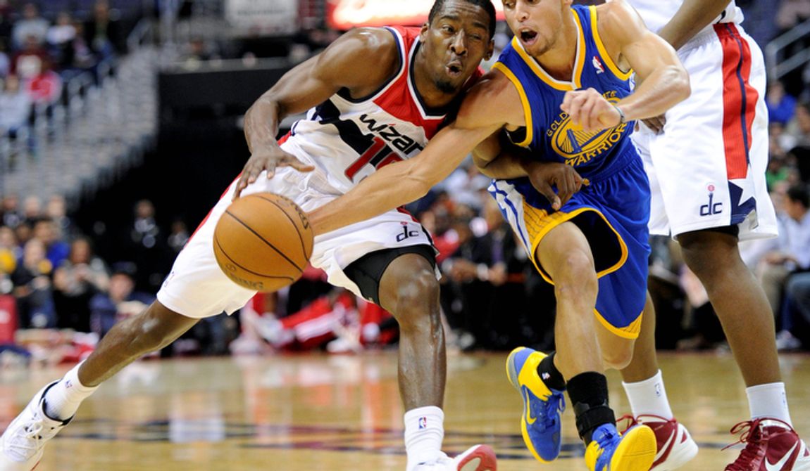 Golden State Warriors guard Stephen Curry (right) tries to get the ball away from Washington Wizards guard Jordan Crawford (left) during the second half of the Warriors&#x27; 101-97 win on Dec. 8, 2012, in Washington. (Associated Press)
