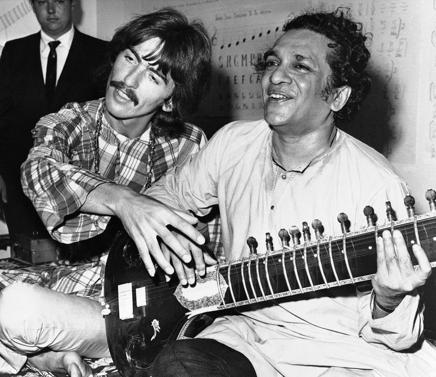 Ravi Shankar shows George Harrison of the Beatles how to play the sitar in Los Angeles in August 1967. Mr. Shankar, the father of singer Norah Jones of the Little Willies, died Tuesday at 92. (Associated Press)