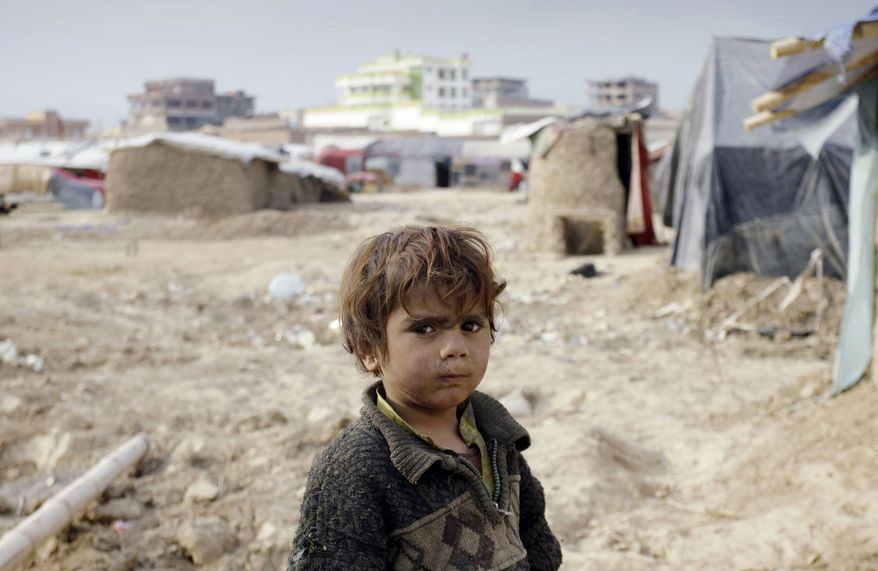 An displaced Afghan child stands at a refugee camp on the outskirts of Kabul, Afghanistan, on Wednesday, Dec. 12, 2012. More than 2 million Afghans are at risk from cold, disease and malnutrition this winter as an international appeal for funds to help one of the world's poorest countries has fallen drastically short of its goal, the United Nations and several humanitarian agencies warned on Wednesday. (AP Photo/Musadeq Sadeq)
