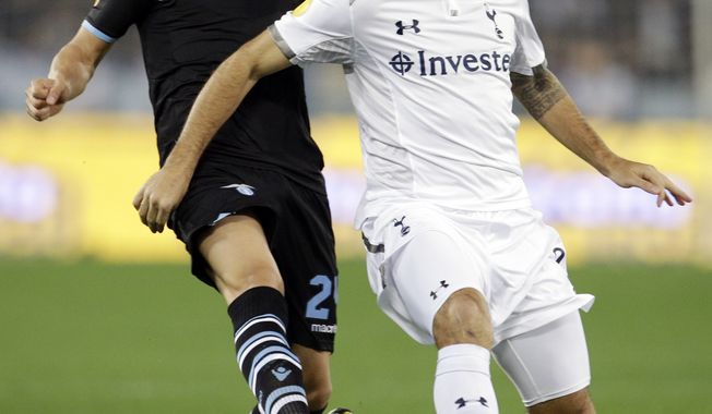 Lazio midfielder Cristian Ledesma, left, and Tottenham Hotspur's Clint Dempsey fight for the ball during an Europa League Group J soccer match at Rome's Olympic stadium, Thursday, Nov. 22, 2012. (AP Photo/Andrew Medichini)