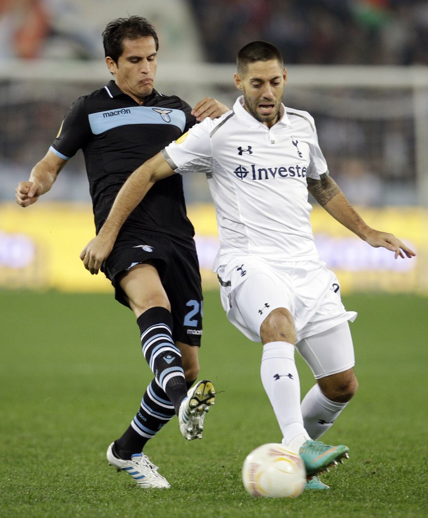 Lazio midfielder Cristian Ledesma, left, and Tottenham Hotspur's Clint Dempsey fight for the ball during an Europa League Group J soccer match at Rome's Olympic stadium, Thursday, Nov. 22, 2012. (AP Photo/Andrew Medichini)
