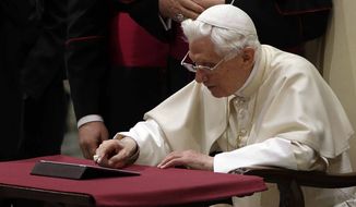 Pope Benedict XVI pushes a button on a tablet at the Vatican last December. In perhaps the most drawn out Twitter launch ever, Pope Benedict XVI pushed the button on a tablet brought to him at the end of his general audience Wednesday. It read: &quot;Dear friends, I am pleased to get in touch with you through Twitter. Thank you for your generous response. I bless all of you from my heart.&quot; (AP Photo/Gregorio Borgia)

